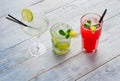 Colorful cocktails. Mojito, Red Cocktail with ice and lime, Margarita on wooden table close up . Royalty Free Stock Photo