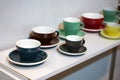 Colorful coffee cups lined up on the table Royalty Free Stock Photo