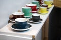 Colorful coffee cups lined up on the table Royalty Free Stock Photo