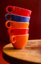 Colorful coffee cups stacked on an old wooden table Royalty Free Stock Photo