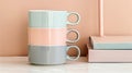 Colorful coffee mugs on the table in front of pink wall