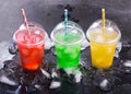 Colorful cold drinks in plastic cups with ice