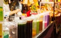 Colorful Cold Thai Milk Ice Tea in jugs on the street food market stall. Traditional Thai Beverage made with milk, sugar and tea Royalty Free Stock Photo