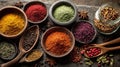 Assortment of Vibrant Spices Displayed in Bowls and Wooden Spoons on Stone Royalty Free Stock Photo