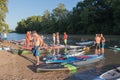 A colorful collection of paddle boards and people Royalty Free Stock Photo