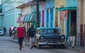 Colorful Colonial aged town with classic car, building, intersection, cobblestone street in Trinidad, Cuba, America.