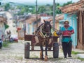 Colorful Colonial tradition town with classic carriage, farmer, cobblestone street in Trinidad, Cuba, America.