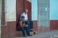 Colorful Colonial Caribbean town people and street beat capture with classic house and wall in Trinidad, Cuba, America. Royalty Free Stock Photo