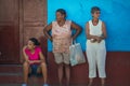 Traditional Colonial Caribbean town people woman with classic colorful house and wall in Trinidad, Cuba, America.