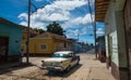 Colorful Colonial Caribbean aged town with cobblestone street, classic car and house, Trinidad, Cuba, America. Royalty Free Stock Photo