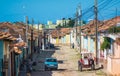 Colorful Colonial Caribbean historic village town with cobblestone street, classic car and house, Cuba, America. Royalty Free Stock Photo