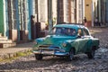 Colorful Colonial old town with classic car, building, cobblestone street in Trinidad, Cuba, America.