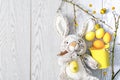 Colorful colored Easter Yellow and orange chicken eggs in decor bucket with rabbit bunny toy, spring, easter flat lay concept.copy Royalty Free Stock Photo