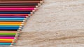 Colorful colored pencils arranged on a wooden table Royalty Free Stock Photo