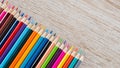 Colorful colored pencils arranged on a wooden table Royalty Free Stock Photo