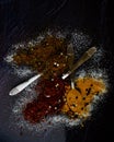Colorful combination of spices on a black plate Royalty Free Stock Photo