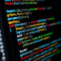 Colorful computer code displayed on a dark screen Royalty Free Stock Photo