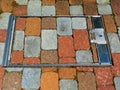 Colorful concrete brick paving infill in stainless steel service door frame