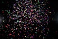 colorful confetti background. red, blue, green, yellow on black. carnival decoration Royalty Free Stock Photo