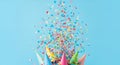 Colorful Confetti Exploding From Party Hats on Light Blue Background Royalty Free Stock Photo