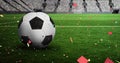 Colorful confetti falling against over close up of soccer ball in sports stadium Royalty Free Stock Photo