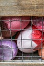 Painted egg shells in wooden wired container Royalty Free Stock Photo