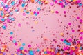 Colorful confetti on pink background. Flat lay, top view