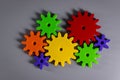 Colorful connected gears on gray background