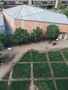 Colorful and cornered architecture from above with green trees, saturated grass