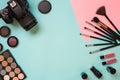 Colorful cosmetics on blue workplace with copy space. Cosmetics make up artist objects: lipstick, eye shadows, powder Royalty Free Stock Photo