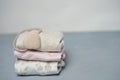 Colorful cotton folded clothes stack on white table empty space background,baby laundry. Royalty Free Stock Photo