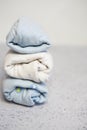 Colorful cotton folded clothes stack on white table empty space background,baby laundry. Royalty Free Stock Photo