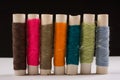 Colorful cotton yarns on rolls for sewing. Thread spools used in fabric and textile industry Royalty Free Stock Photo