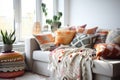 a colorful and cozy arrangement of blankets and cushions on a white sofa