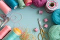 Colorful craft materials on blue surface, spools, yarn, scissors evoke artistic expression Royalty Free Stock Photo