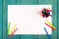 colorful crayons and blank paper on the desk Royalty Free Stock Photo