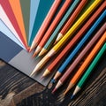 Colorful crayons and stack of drawing papers on wooden table. Square frame., Royalty Free Stock Photo