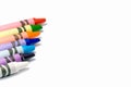 Colorful crayons on a white background with text space