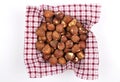 Hazelnuts on cloth in bamboo bowl