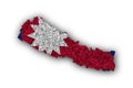 Map and flag of Nepal on poppy seeds