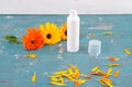 Natural cosmetics and common marigold on weathered concrete