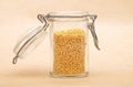 Raw millet in jar and on brown background Royalty Free Stock Photo