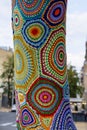 Colorful crochet knit on tree trunk in Kyiv, Ukraine. Street art goes by different names, graffiti knitting, yarn bombing. Royalty Free Stock Photo