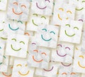 Colorful crumpled adhesive notes with smiling faces