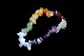 Colorful crystal chakras bracelet isolated on black