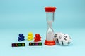 Game Time: Colorful letter cubes, dice, figurines and hourglass.