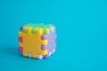 Colorful cubic assembly toy on blue background copy space. Business finance, problem solving, brainstorming, teamwork, creative Royalty Free Stock Photo