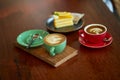 Colorful cup of coffee on wooden table Royalty Free Stock Photo