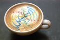 Colorful cup of frothy coffee