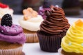 Colorful cupcakes with different Tastes. Small beautifull cakes on white table top. Close up